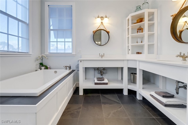 bathroom with tile patterned flooring, vanity, and a tub