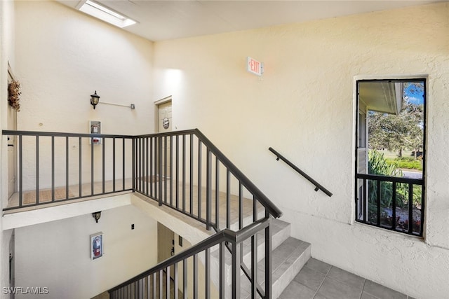 stairs featuring tile patterned flooring