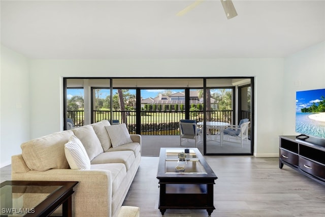 living room featuring hardwood / wood-style flooring and ceiling fan