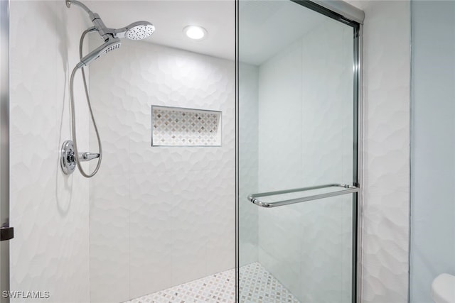 bathroom featuring a shower with shower door