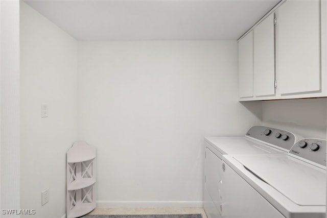 washroom with cabinets and separate washer and dryer