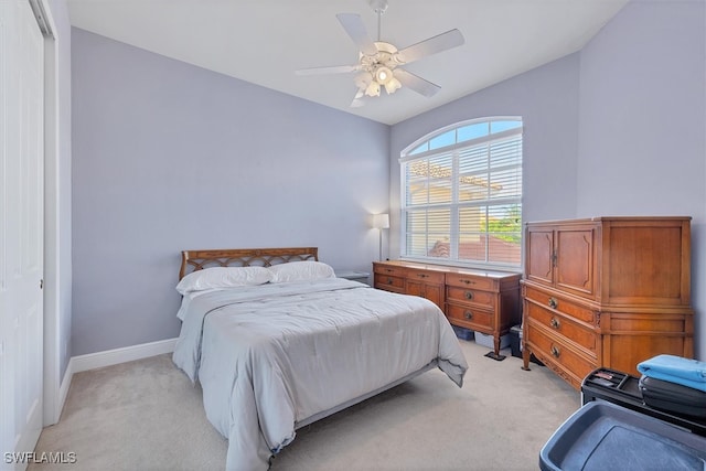 bedroom featuring ceiling fan, light colored carpet, and lofted ceiling