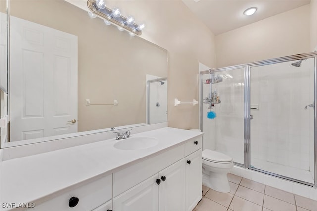 bathroom featuring tile patterned floors, toilet, an enclosed shower, and vanity