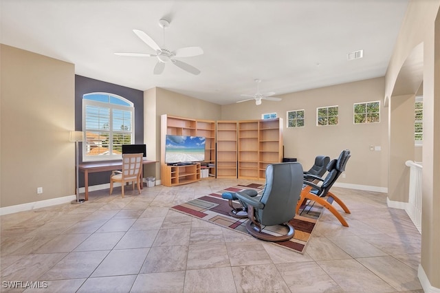 interior space with ceiling fan