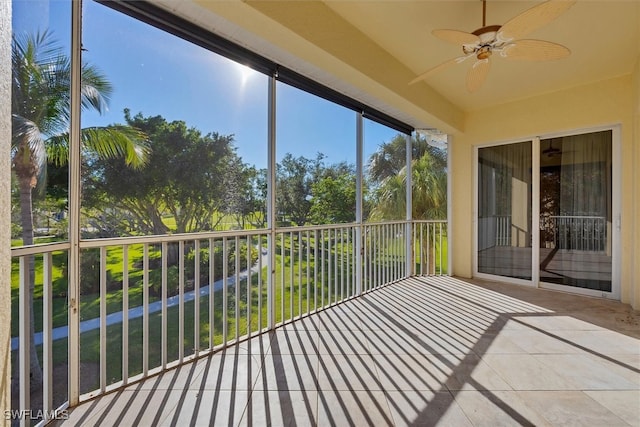 unfurnished sunroom featuring ceiling fan