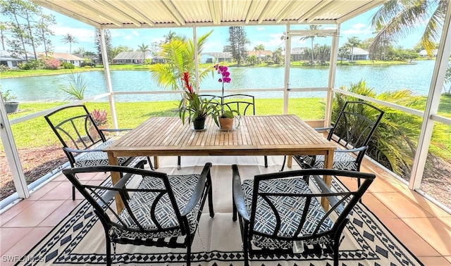 sunroom / solarium featuring a water view