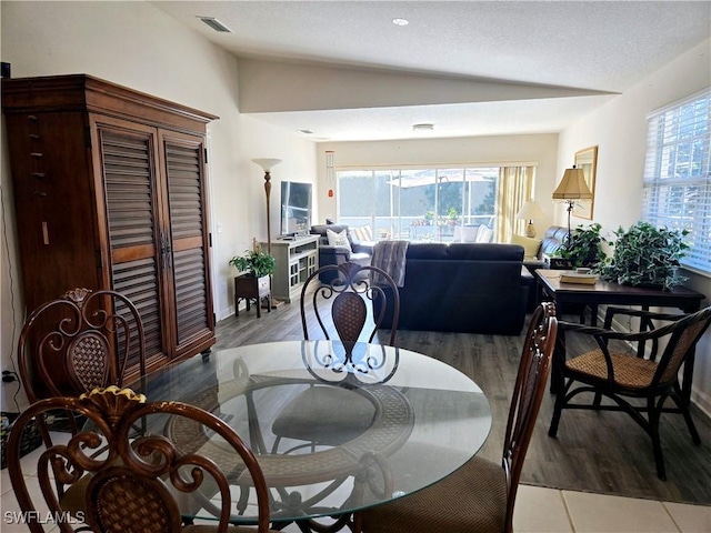 dining space featuring lofted ceiling