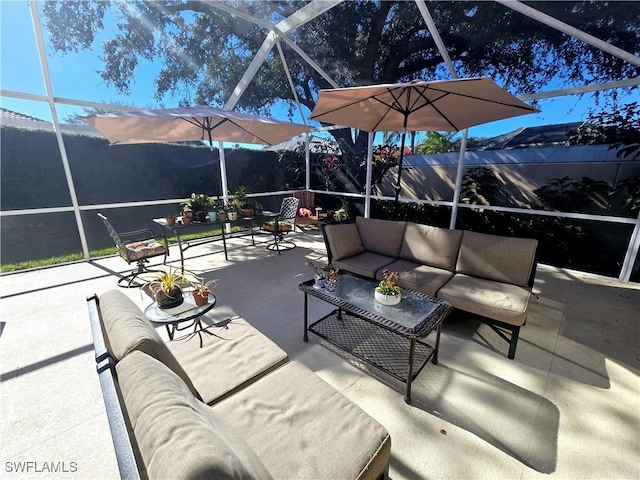 view of patio / terrace featuring an outdoor living space, a lanai, and a mountain view