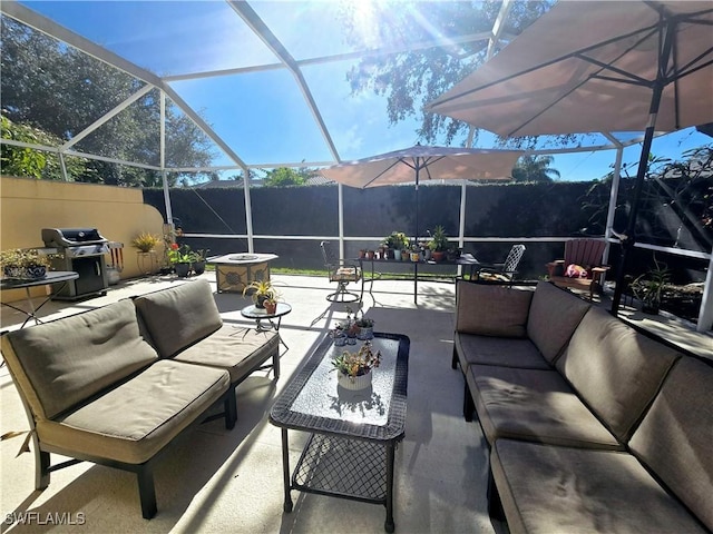 view of patio / terrace featuring a grill, outdoor lounge area, a mountain view, and a lanai