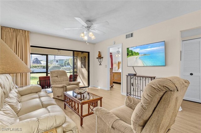 living room featuring ceiling fan and light hardwood / wood-style floors