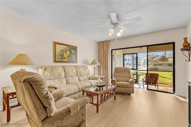 living room with ceiling fan and light hardwood / wood-style floors