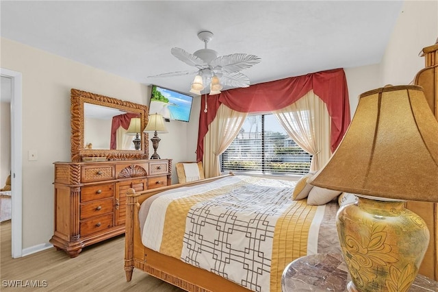 bedroom with light hardwood / wood-style floors and ceiling fan