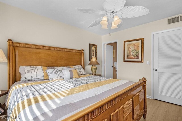 bedroom with ceiling fan and light hardwood / wood-style flooring