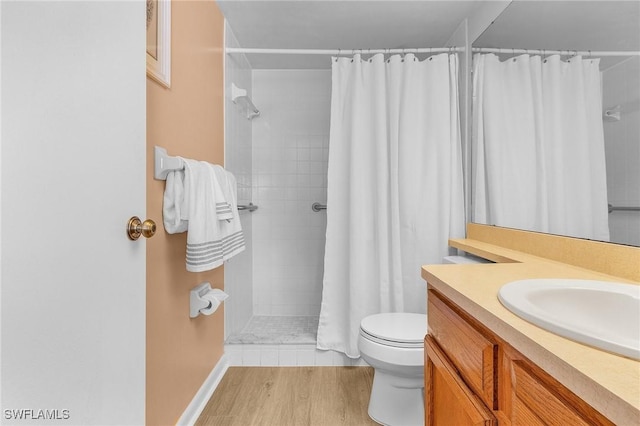 bathroom featuring walk in shower, vanity, toilet, and hardwood / wood-style flooring