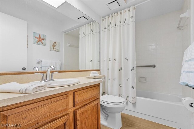 full bathroom with toilet, vanity, shower / bathtub combination with curtain, and hardwood / wood-style flooring