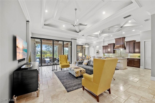 living room with coffered ceiling, crown molding, ceiling fan, and a high ceiling