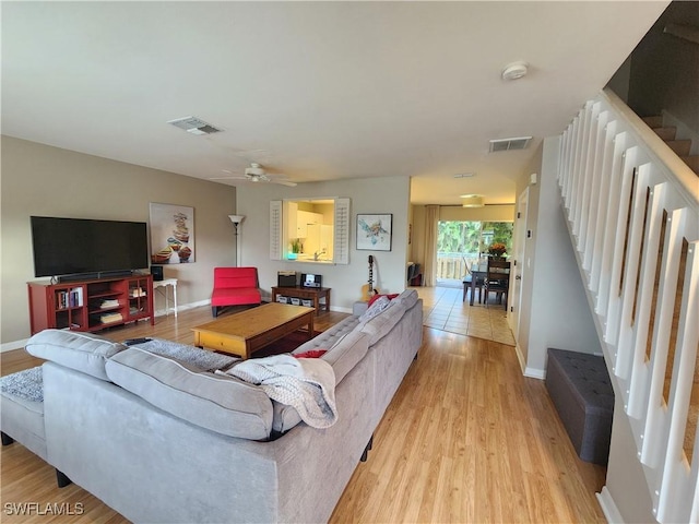 living room featuring light hardwood / wood-style floors and ceiling fan