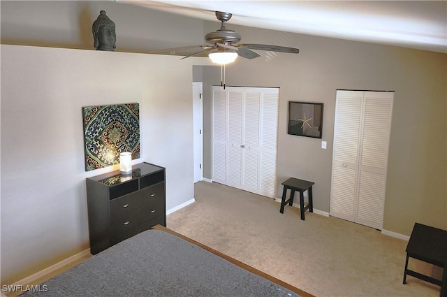 carpeted bedroom with two closets and ceiling fan