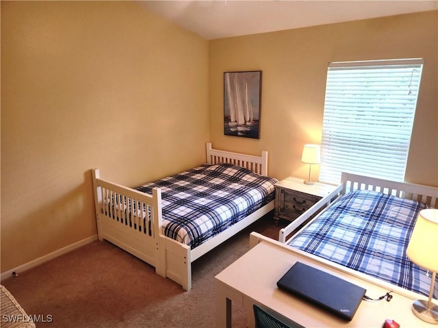 bedroom featuring dark carpet