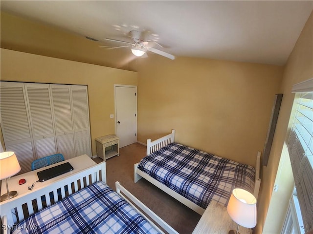 bedroom with a closet, ceiling fan, vaulted ceiling, and carpet floors