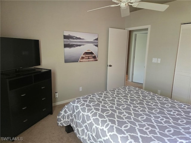 carpeted bedroom featuring ceiling fan and a closet