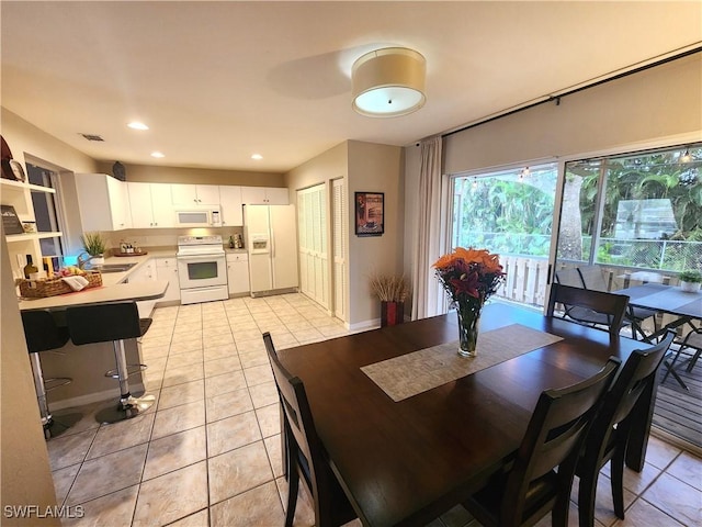 dining space featuring light tile patterned floors