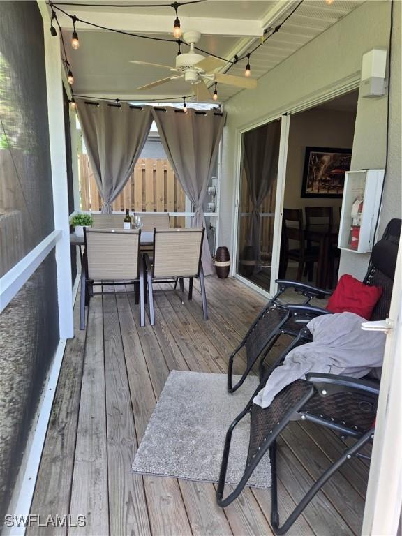 wooden deck featuring ceiling fan