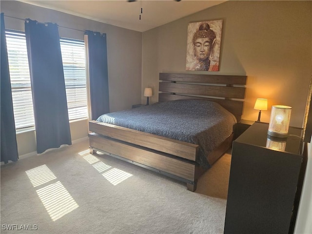 bedroom featuring carpet flooring and lofted ceiling