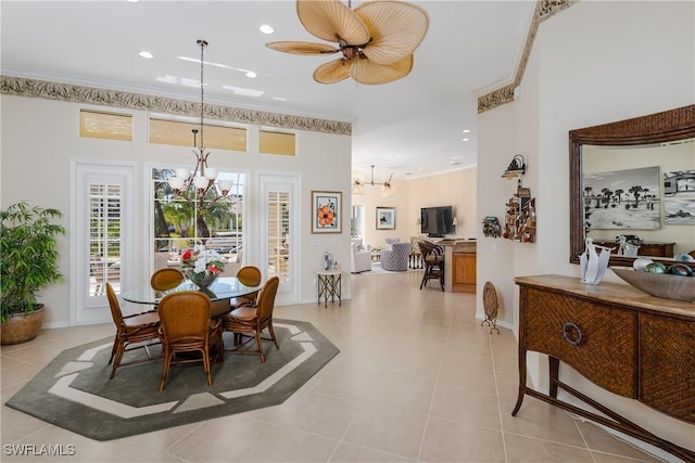 dining room with ceiling fan with notable chandelier, light tile patterned floors, and ornamental molding