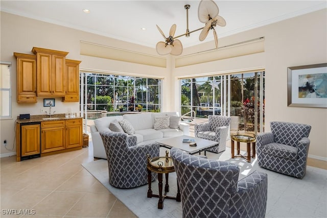 living room with ornamental molding, sink, a notable chandelier, and light tile patterned flooring