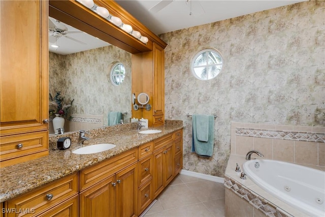 bathroom featuring tile patterned flooring, vanity, tiled bath, and a wealth of natural light