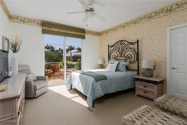 bedroom featuring access to exterior, ceiling fan, and carpet