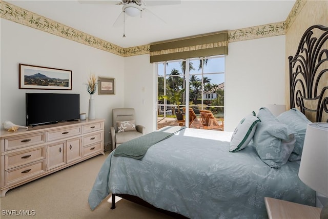 carpeted bedroom featuring access to exterior and ceiling fan