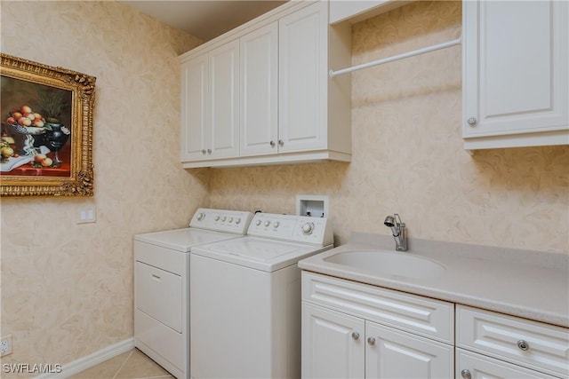 washroom featuring cabinets, independent washer and dryer, light tile patterned floors, and sink