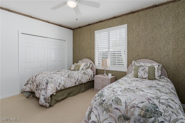 bedroom with carpet, a closet, ceiling fan, and crown molding