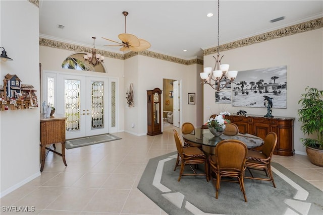 dining area featuring ceiling fan with notable chandelier, ornamental molding, light tile patterned floors, and french doors