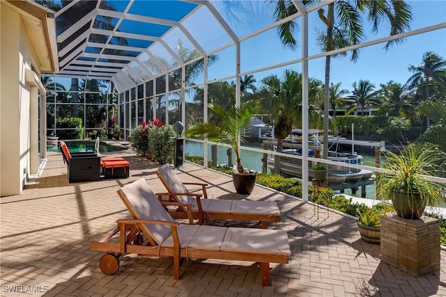 sunroom with a water view and lofted ceiling