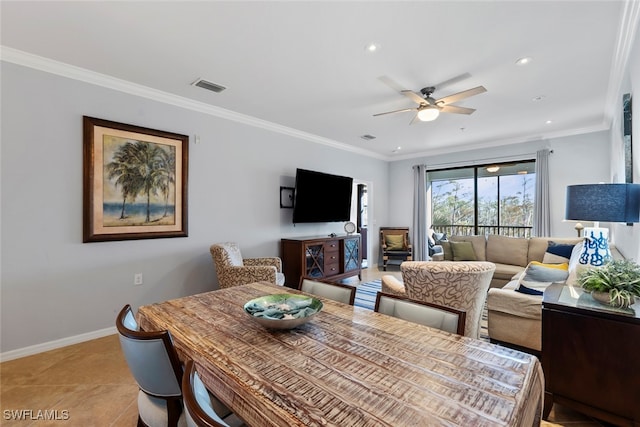 dining space with ceiling fan, light tile patterned floors, and ornamental molding