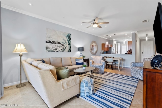 living room featuring ceiling fan, ornamental molding, and light tile patterned flooring