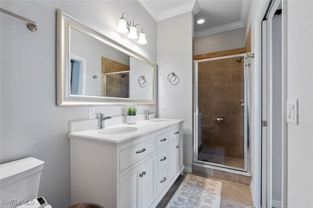 bathroom with tile patterned floors, crown molding, toilet, a shower with door, and vanity