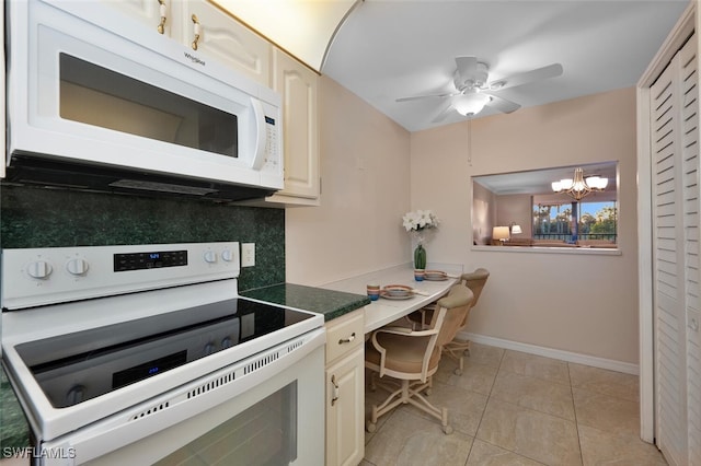 kitchen with light tile patterned flooring, white appliances, ceiling fan with notable chandelier, and decorative backsplash