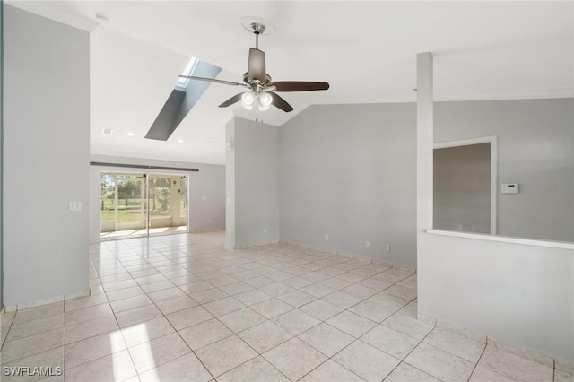 unfurnished room featuring light tile patterned floors, ceiling fan, and lofted ceiling with skylight