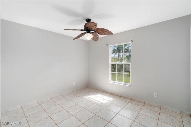 spare room with light tile patterned floors and ceiling fan