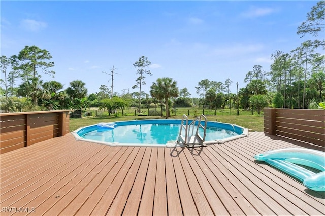 pool featuring a yard and a wooden deck