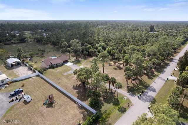 birds eye view of property featuring a view of trees