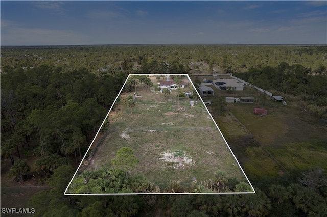 birds eye view of property with a wooded view