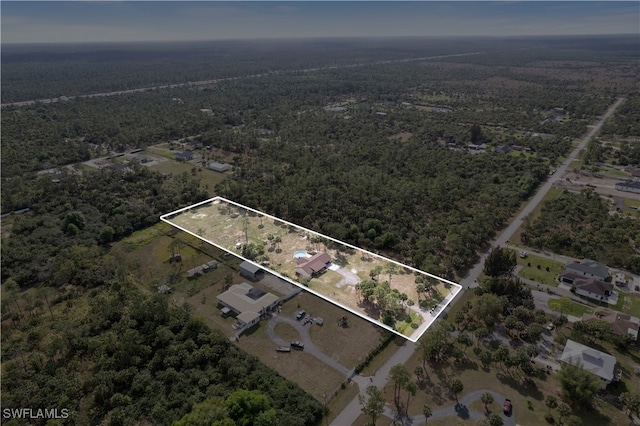 birds eye view of property featuring a view of trees