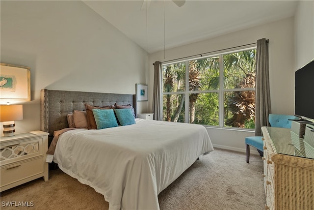 bedroom featuring light colored carpet, multiple windows, lofted ceiling, and ceiling fan