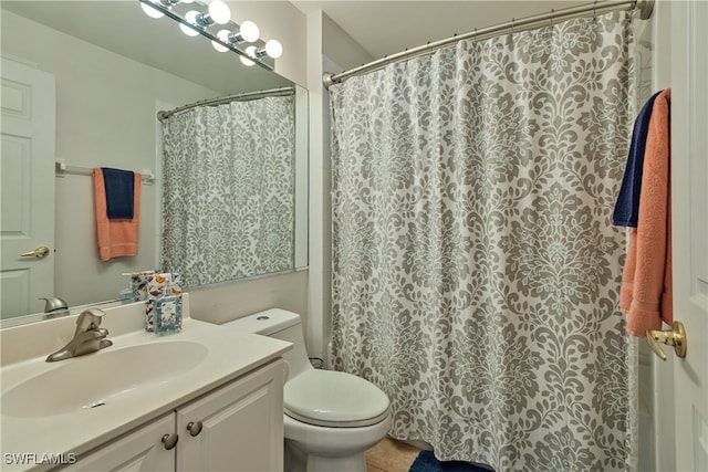 bathroom with tile patterned floors, vanity, and toilet