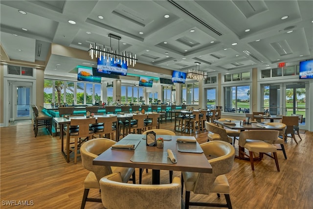 dining space with hardwood / wood-style floors, beamed ceiling, and coffered ceiling